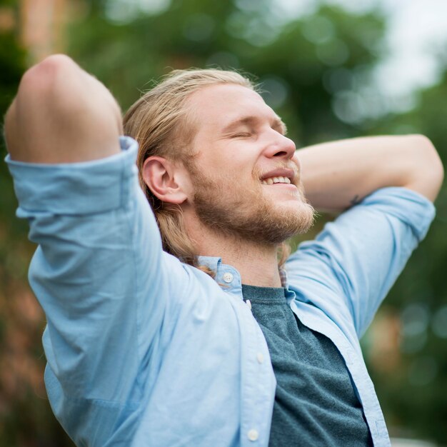 Side view of smiley man outdoors