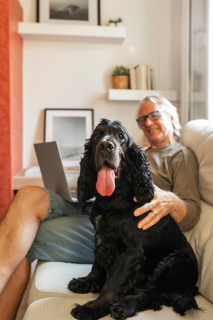 Free photo side view smiley man petting dog