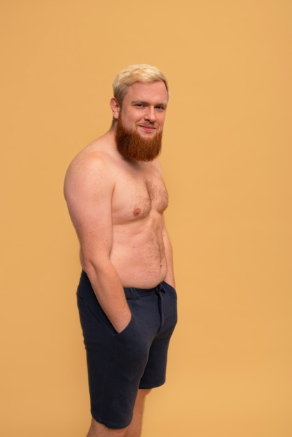 Side view smiley man posing in studio