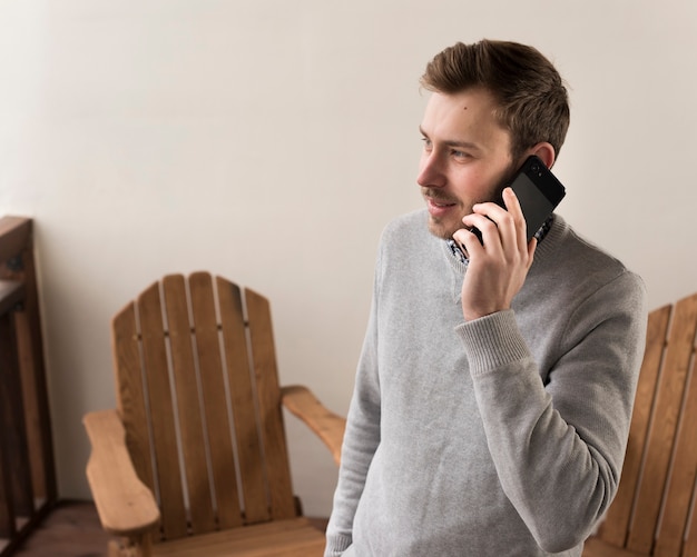 Side view of smiley man talking on the phones