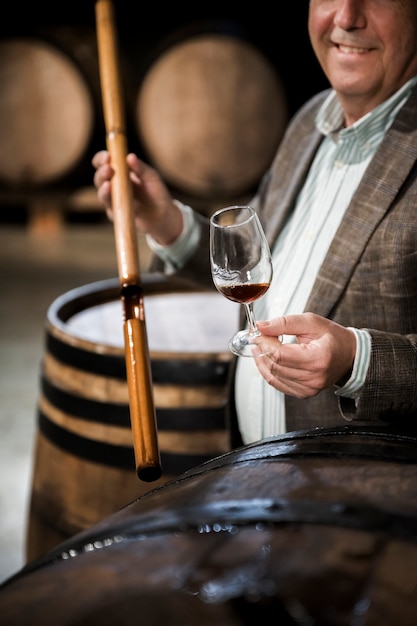 Side view smiley man in wine cellar