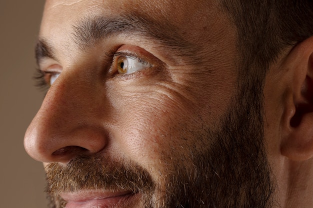 Uomo sorridente di vista laterale con la barba