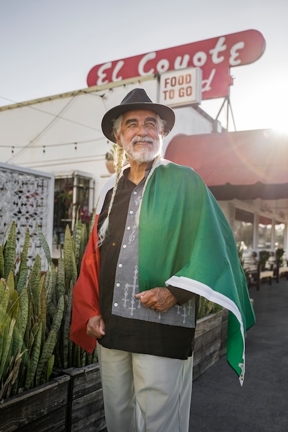 Side view smiley old man with mexican flag