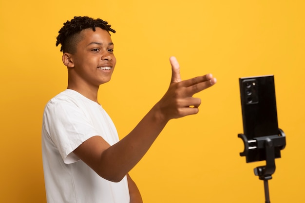 side view smiley teen recording video