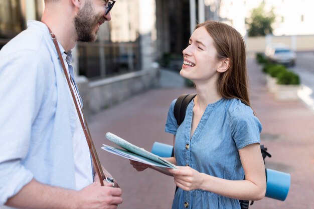 Side view of smiley tourist couple