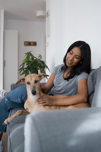 Side view smiley woman and dog on couch