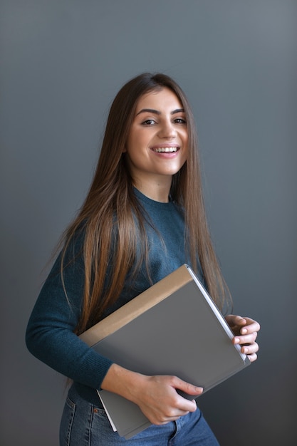 Free photo side view smiley woman holding book