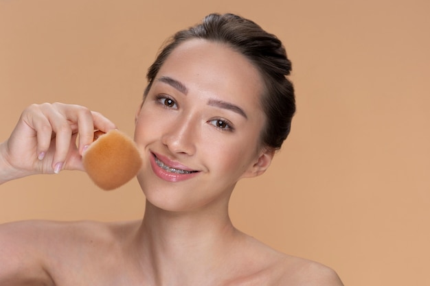 Side view smiley woman holding brush