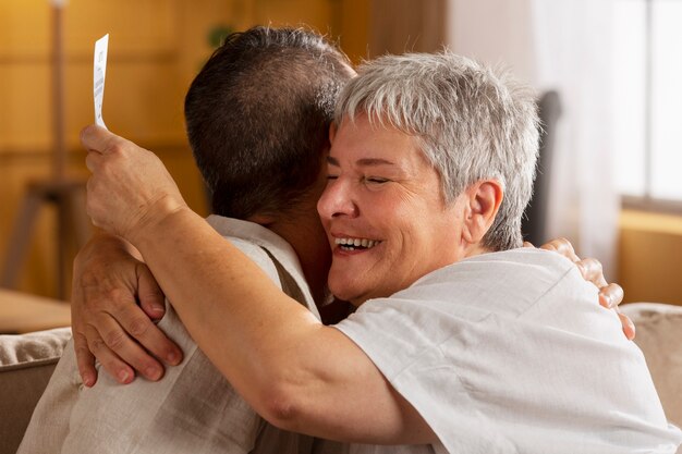 Side view smiley woman hugging man