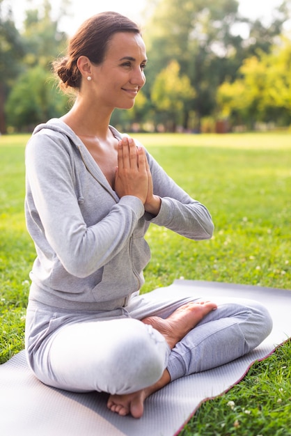 Side view smiley woman meditating pose