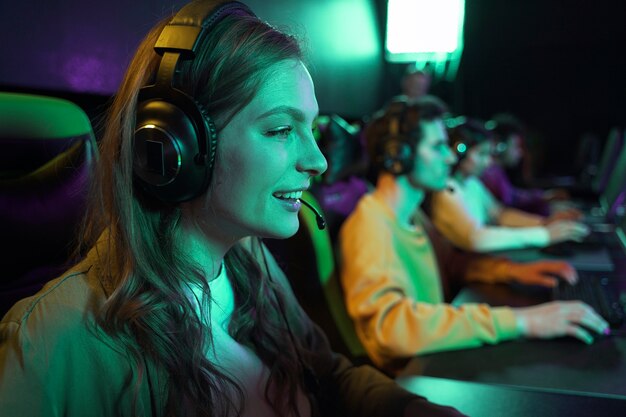 Side view smiley woman playing videogame