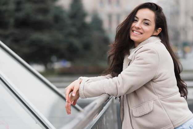 Side view of smiley woman posing outdoors