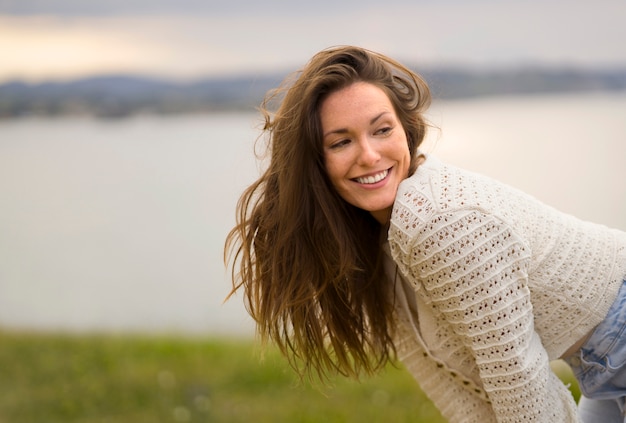 Side view smiley woman posing outdoors