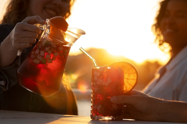 Side view smiley woman pouring sangria