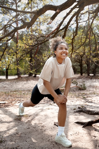 Side view smiley woman stretching