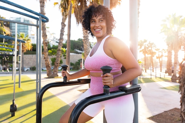 Side view smiley woman training outside