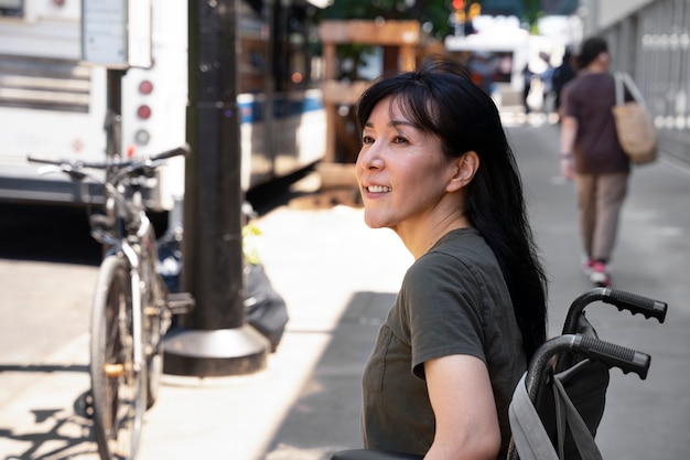 Side view smiley woman in wheelchair