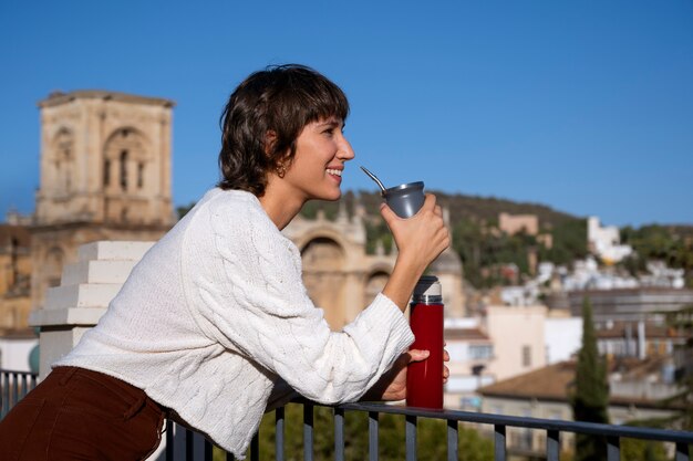 Side view smiley woman with drink