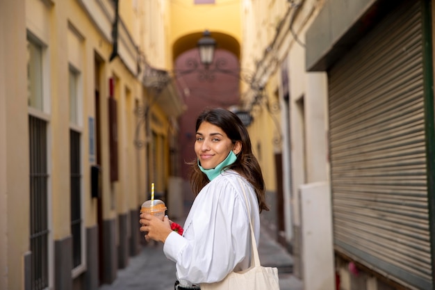 Free photo side view of smiley woman with grocery bags