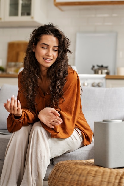 Side view smiley woman with smart speaker