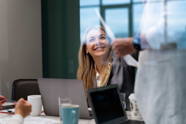 Free photo side view smiley woman at work