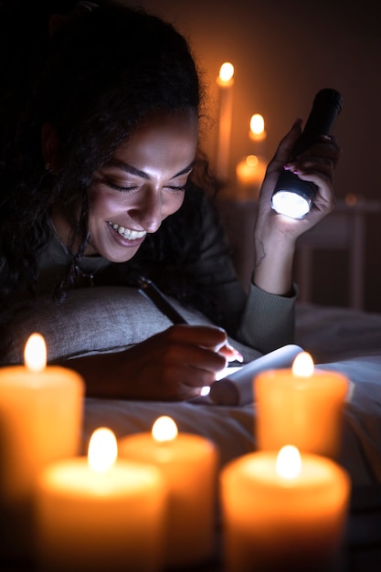 Side view smiley woman writing in bed