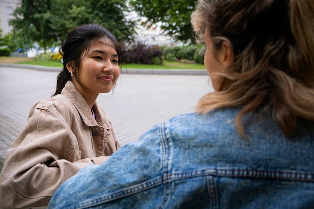 Foto gratuita donne sorridenti di vista laterale all'esterno