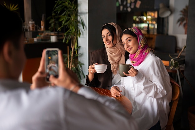 Free photo side view smiley women posing