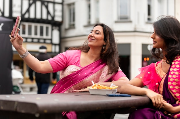 Side view smiley women taking selfie