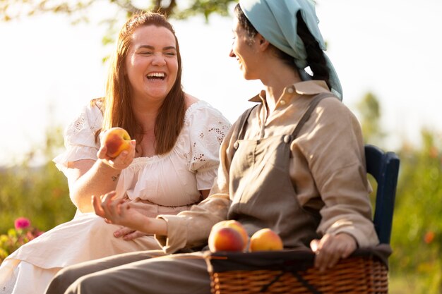 Side view smiley women with fruits