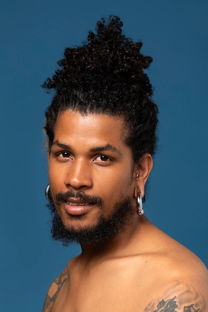 Side view smiley young man posing in studio