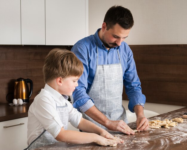 Side view son and father cooking time