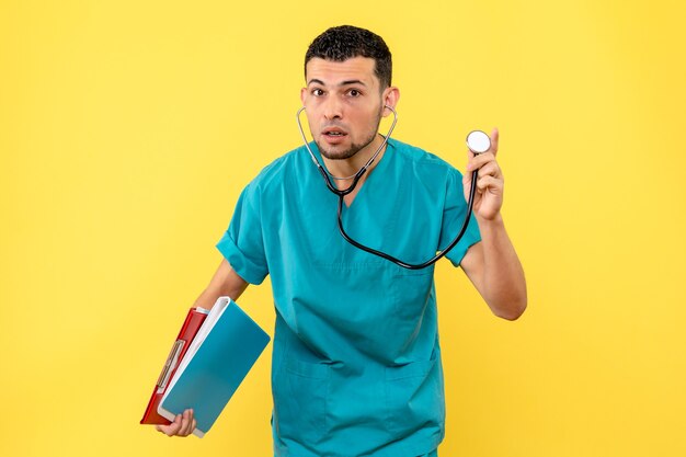 Side view specialist doctor with phonendoscope listens to complaints from patients