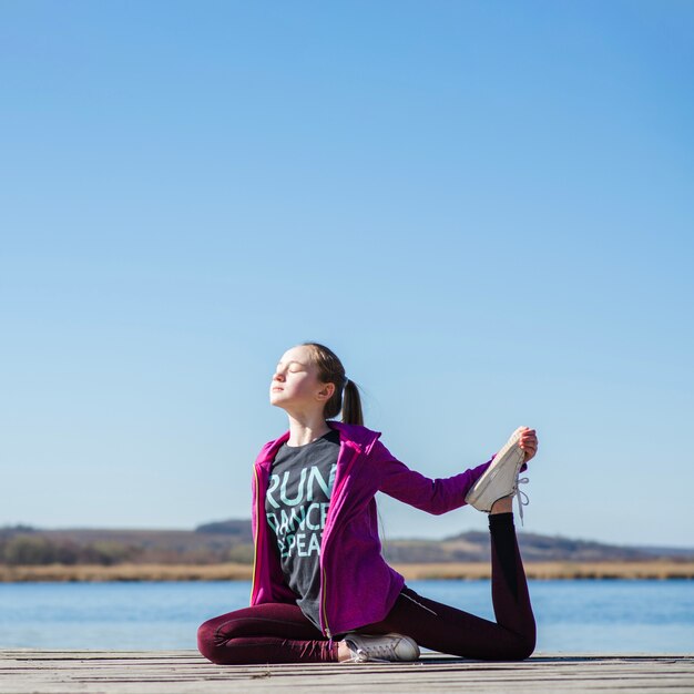 Side view of stretching girl