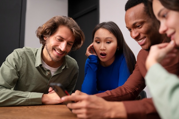 Free photo side view surprised friends reading messages