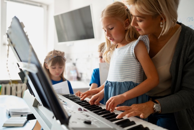 Side view teacher helping kid learn