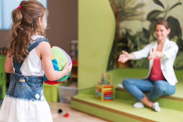 Side view teacher and kid playing