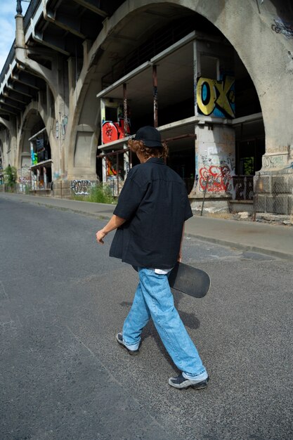 Side view teen walking with smartphone