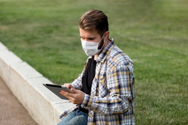 Side view teenager browsing tablet