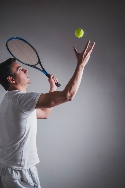Free photo side view of tennis player hitting