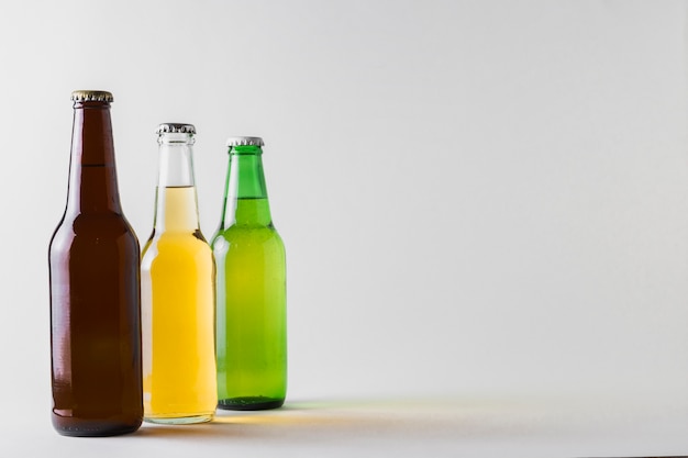 Side view three different beers on table