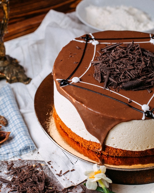 Side view of tiramisu cake topped with chocolate sprinkles on the table