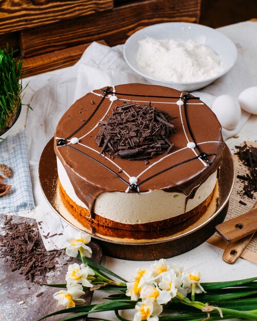 Side view of tiramisu cake topped with chocolate sprinkles on the table