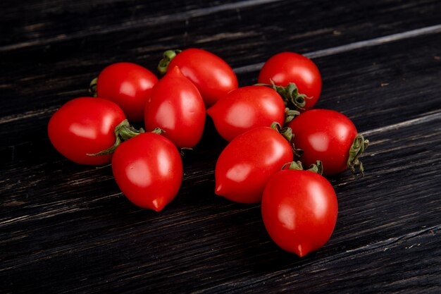 Side view of tomatoes on wooden table