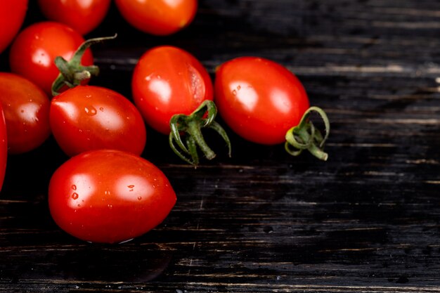 Side view of tomatoes on wooden table