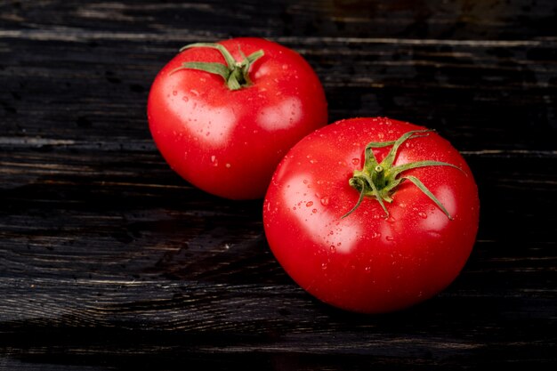 Side view of tomatoes on wooden table