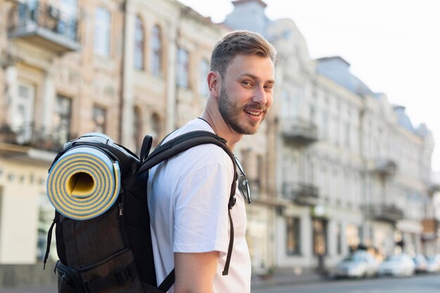 Side view of tourist man with backpack