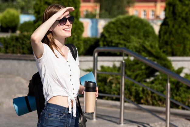 Side view of tourist woman with backpack