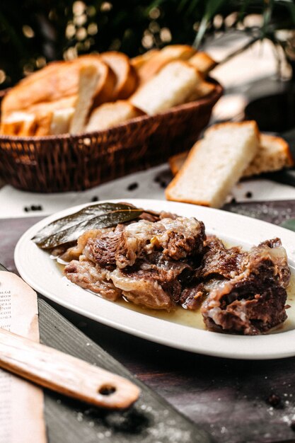 Side view of traditional azerbaijani buglama on a white plate with herbs