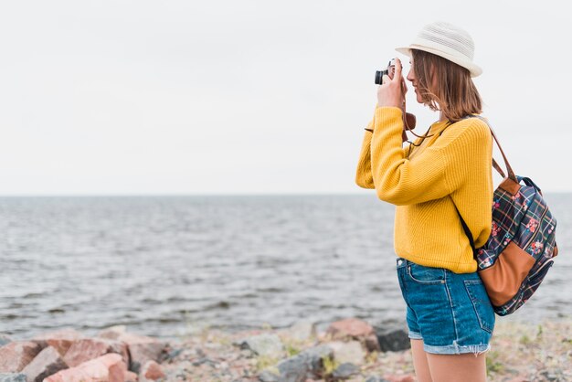 Side view of traveler taking a photo